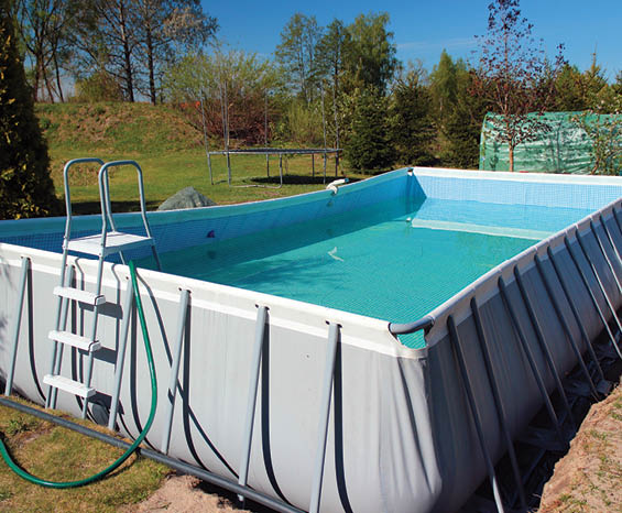 Empty above ground swimming pool in a backyard