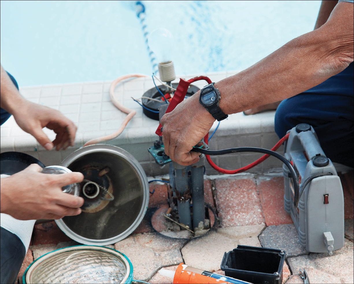 Men working together to repair an outdoor light fixture 