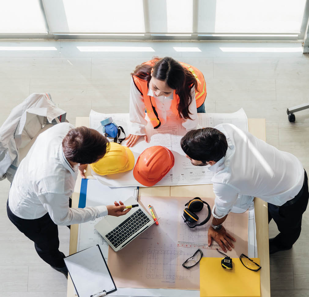 Top view of engineer young asian and caucasian wear safety helmet in new project meeting  Teamwork people engineer consultant entrepreneur casual brainstorm  Industry, Engineer and construction concept 
