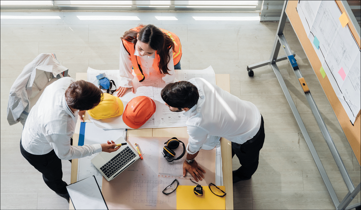 Top view of engineer young asian and caucasian wear safety helmet in new project meeting  Teamwork people engineer consultant entrepreneur casual brainstorm  Industry, Engineer and construction concept 