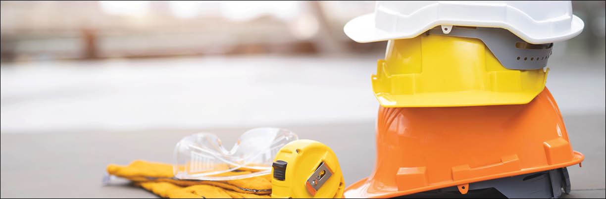 orange, yellow,white hard safety wear helmet hat in the project at construction site building on concrete floor on city  helmet for workman as engineer or worker  concept safety first 