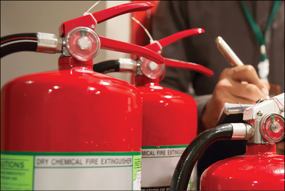 Engineer checking Fire extinguisher 