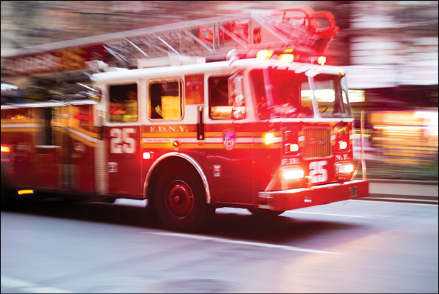 NEW YORK, US - NOVEMBER 21: Motion blurred shot of famous New York fire engine with lights flashing  November 21, 2013 in New York 