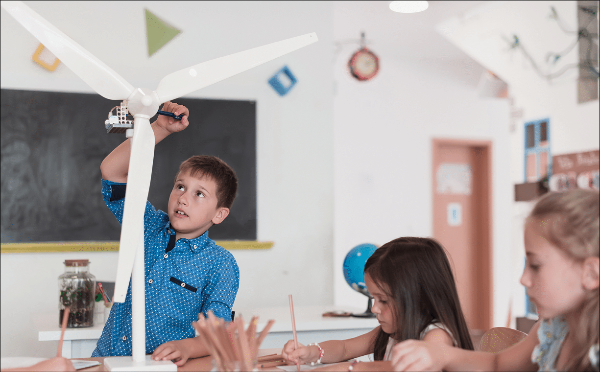 Elementary School Stem Robotics Classroom Diverse Group of Children Building and Programming windmill ecology robot concept. Together Talking and Working as a Team. Creative Robotics Engineering. High