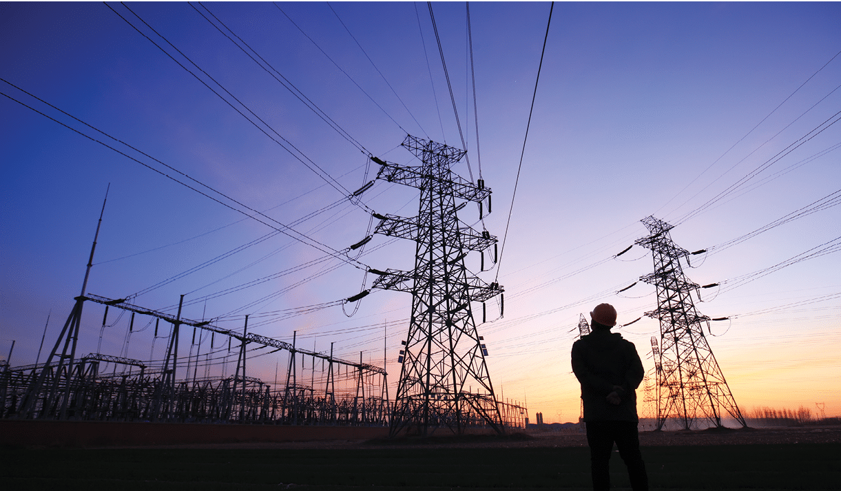 Electricity workers and pylon silhouette