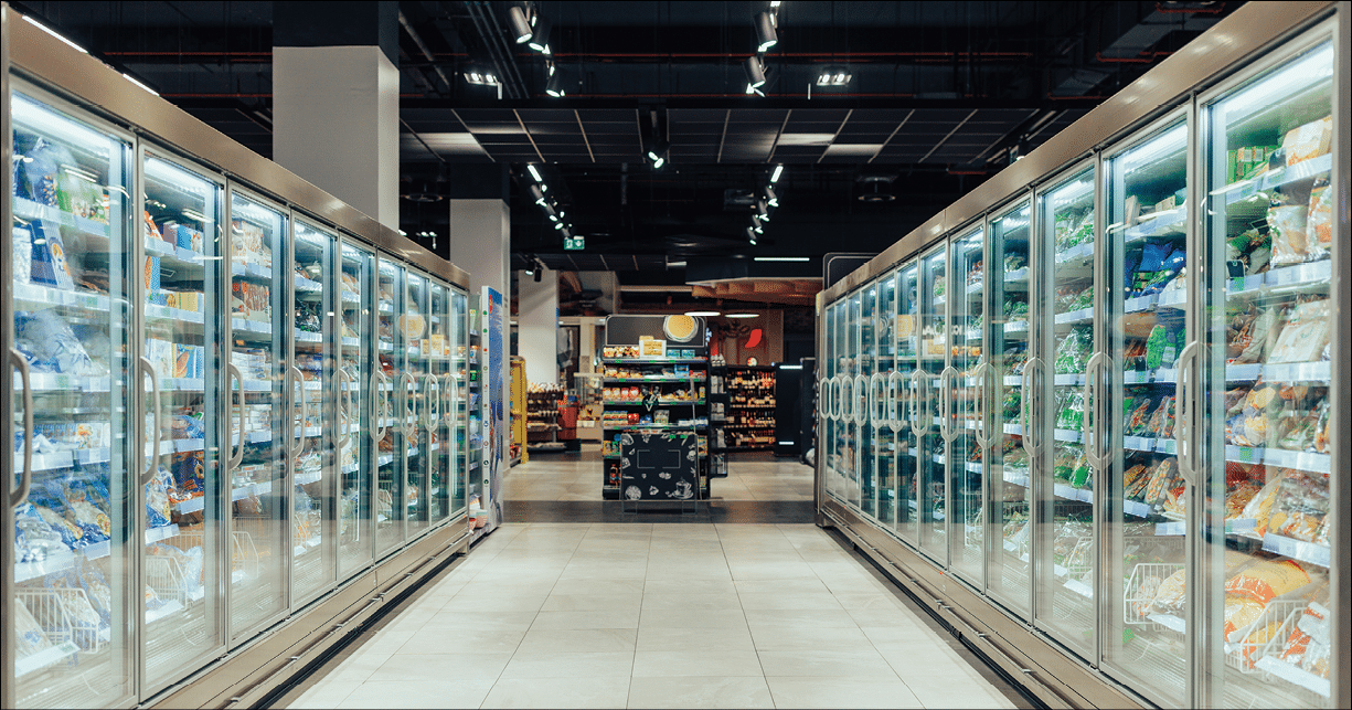 Empty supermarket aisle with freezers showcases with different products
