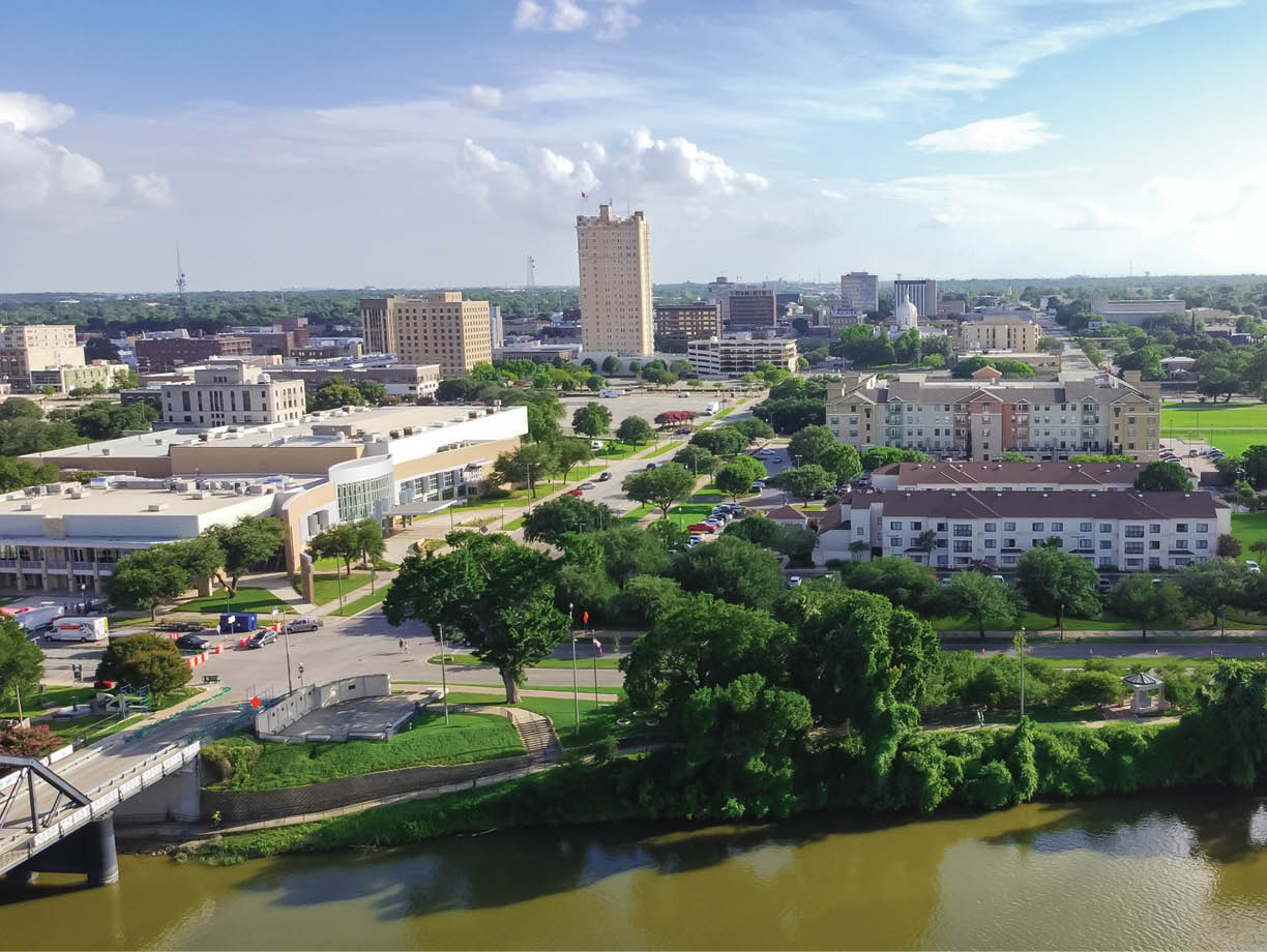 Aerial view riverside downtown Waco and Cultural District from Washington Avenue Bridge cross Brazos River. A city in central Texas with vibrant Cultural District unique locally owned shops, restaurants
