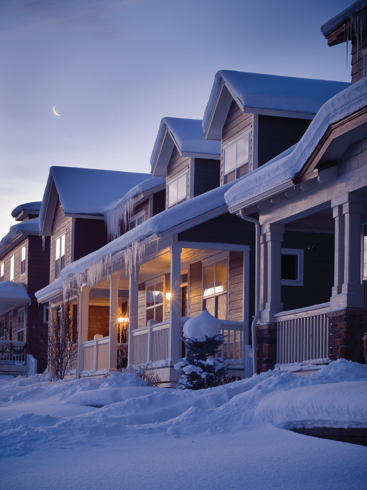 A green track house in winter at night with copy-space 