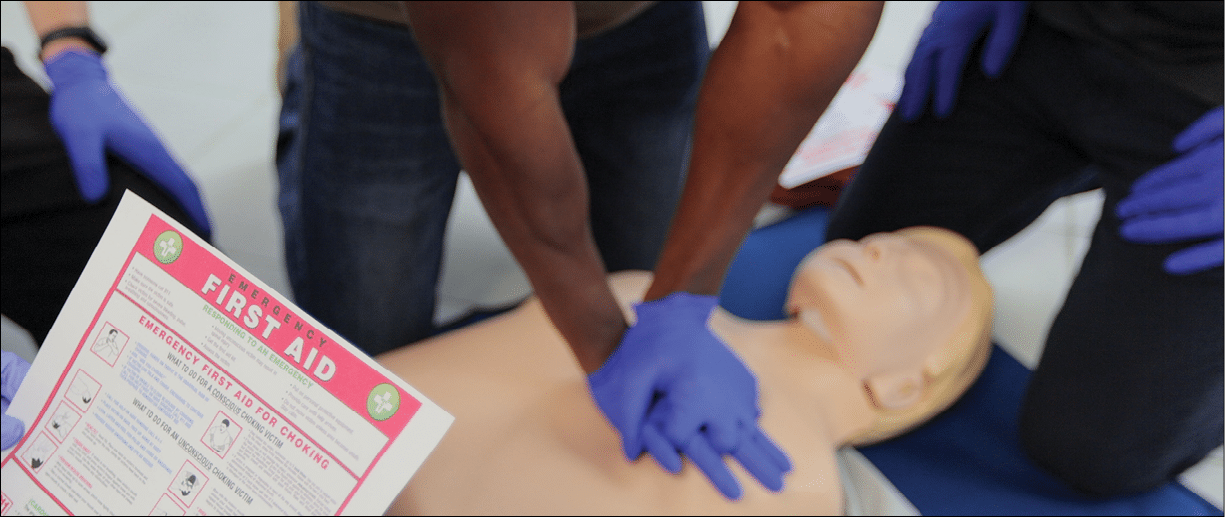 CPR First Aid training concept  Back view of woman holding first aid instruction during cpr training class