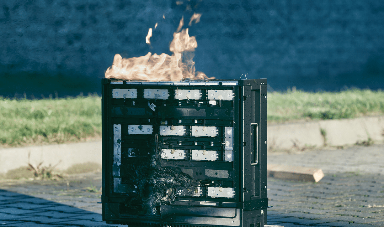 Photovoltaic battery set on fire in a controlled testing environment. Green renewable energy fire safety and improvement tests