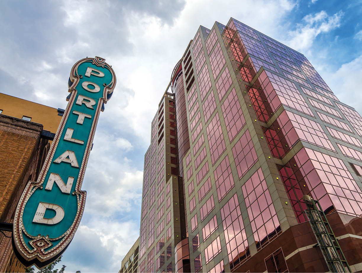 Iconic Portland sign with pink skyscraper rising next to it