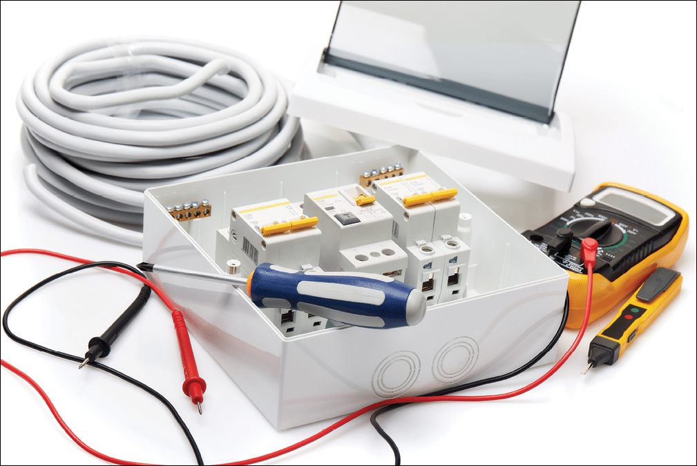 Automatic circuit breakers, distribution box, cable and digital multimeter on a white background. Electrical equipment. Accessories for electrical protection and control