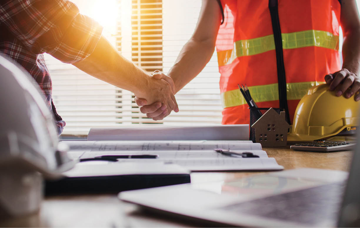Handshake of two business man, after architect working and planning blueprint, Engineering objects on workplace