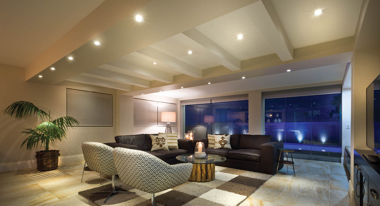 Luxurious living room with big windows, couple of sofas and armchairs