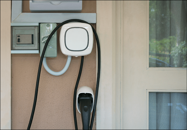 Wall charging station for electric car installed in a residential house.