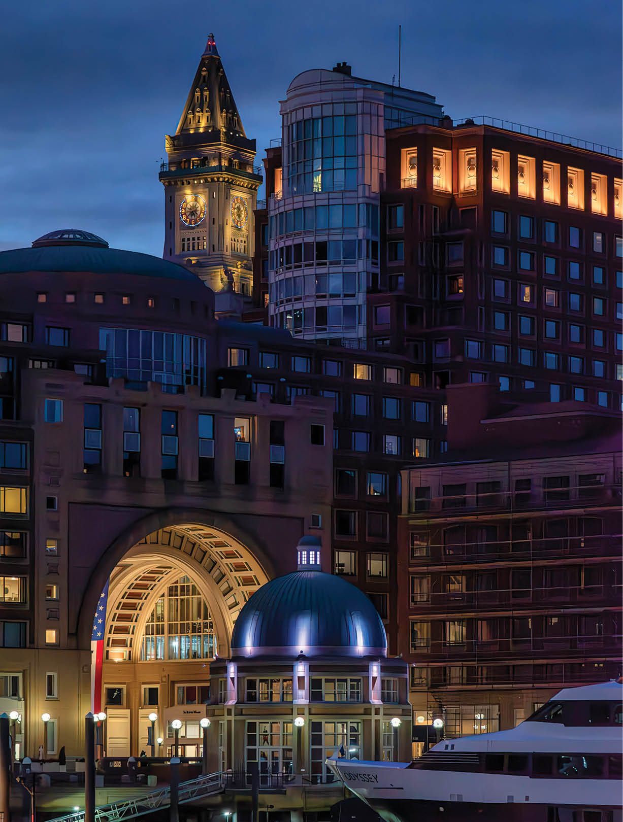 Boston, MA USA Nov 16, 2024: Boston Harbor Hotel seen at dusk from Fan Pier in the Seaport District. The tower of the Custom House (now a Marriott luxury hotel) is in the background.