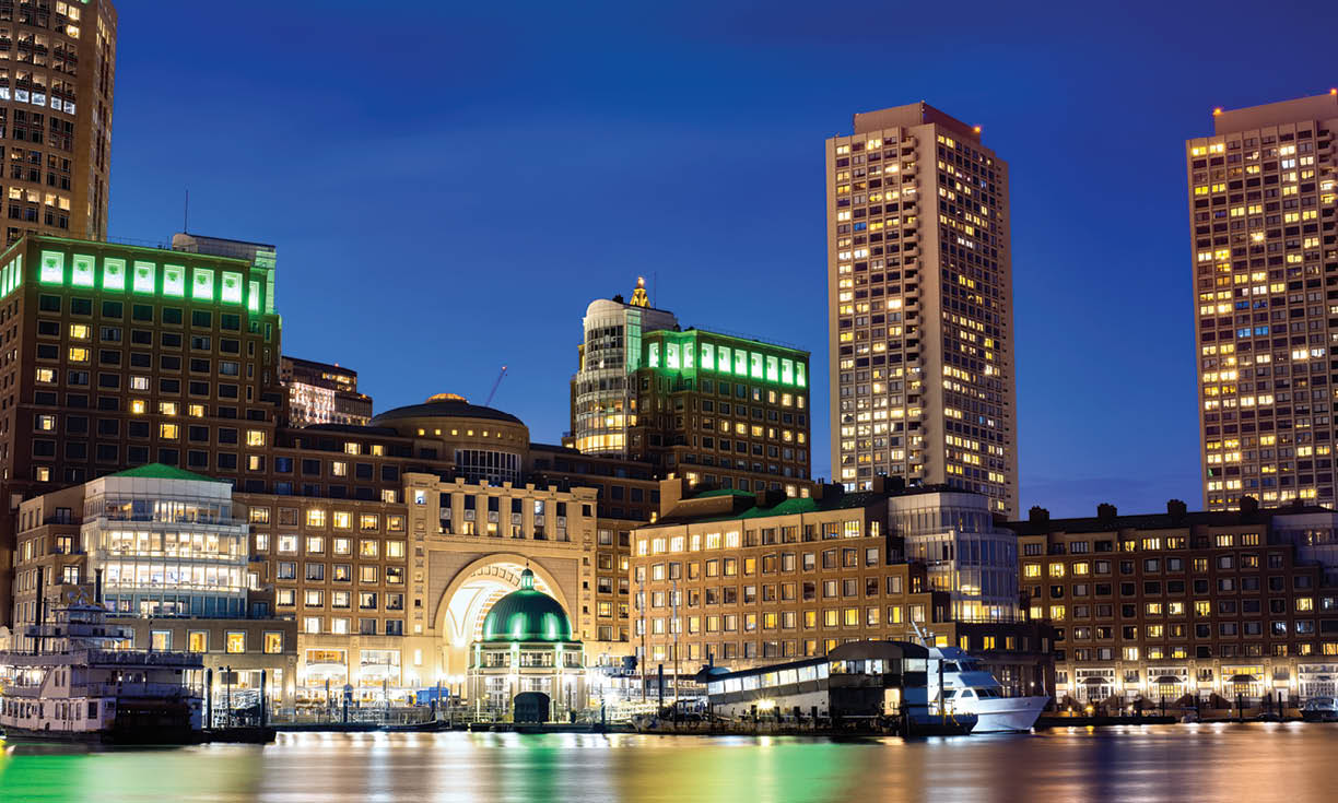 View of Boston downtown at night, water and seaport on the foreground, multiple nightlights, USA