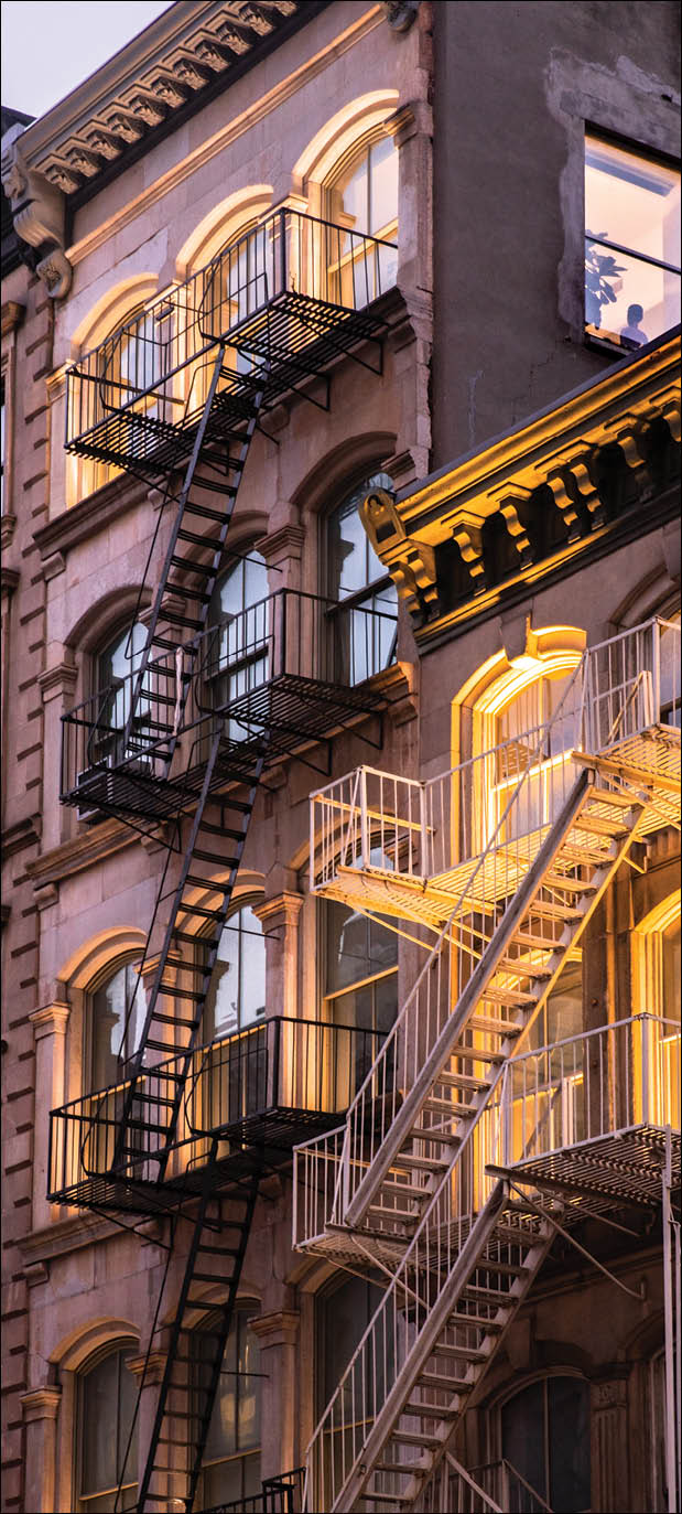View of beautiful New York City apartment buildings lit up in the evening