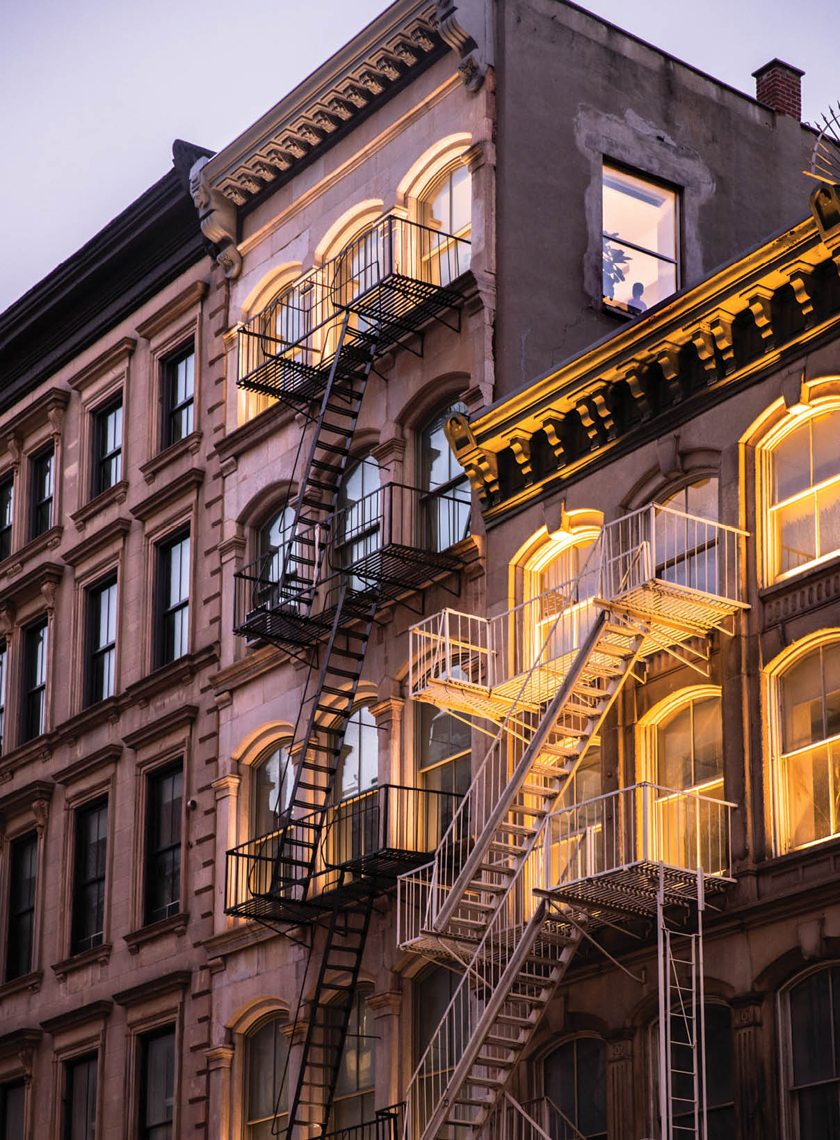 View of beautiful New York City apartment buildings lit up in the evening