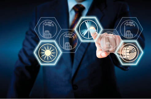 Torso of a corporate manager in business suit reaching out to touch a wind power icon. The active wind symbol is lighting up together with a solar and geothermal energy button. Energy turn metaphor.