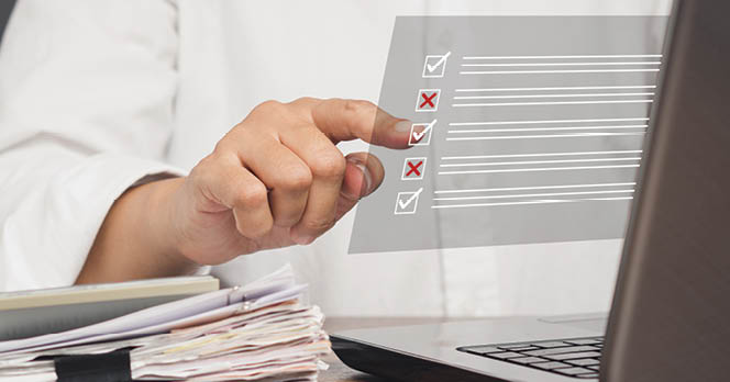 Checklist concept. A Businessman touching a checkmark symbol on a document management system or DMS on a virtual screen. Assessment form, questionnaire, and checklist management