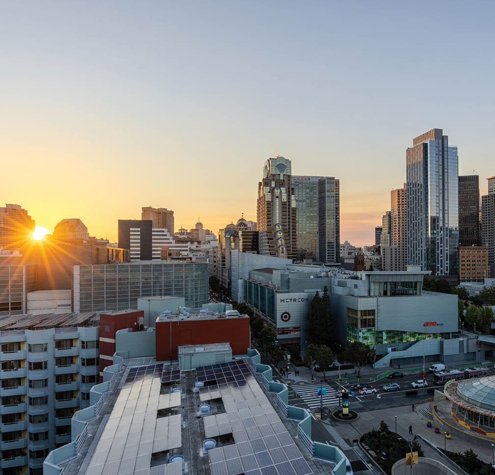 A cityscape with a sunset in the background. Description generated by AI