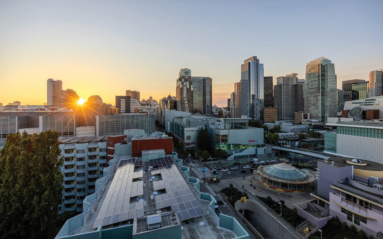 A cityscape with a sunset in the background. Description generated by AI