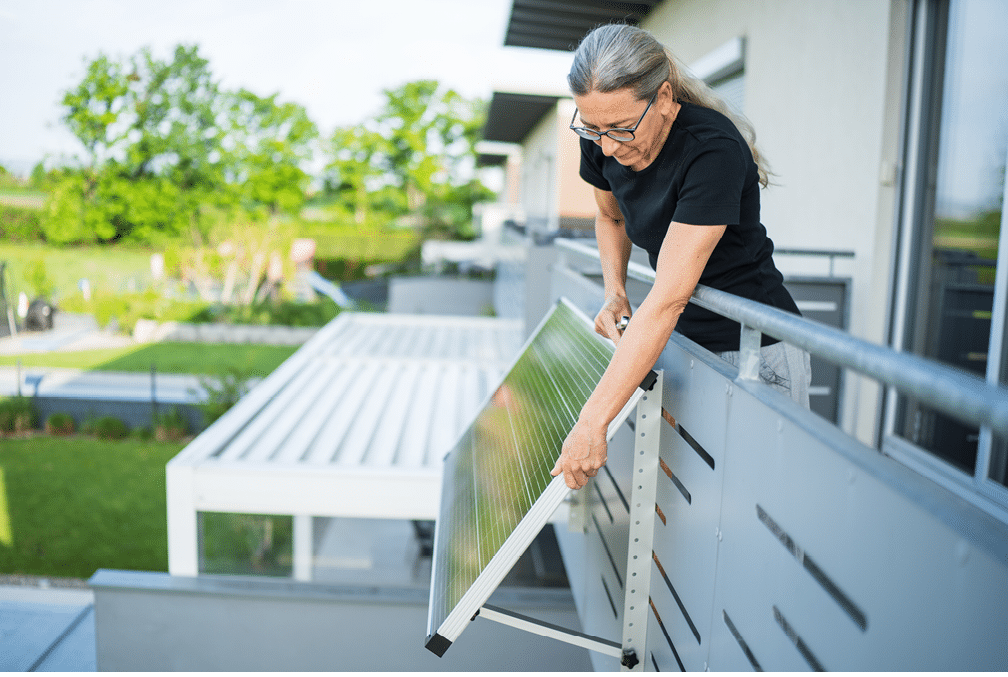 A woman is holding a solar panel. Description generated by AI