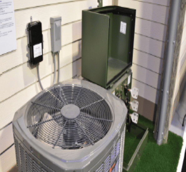 A large air conditioning unit is sitting on a green carpet. Description generated by AI