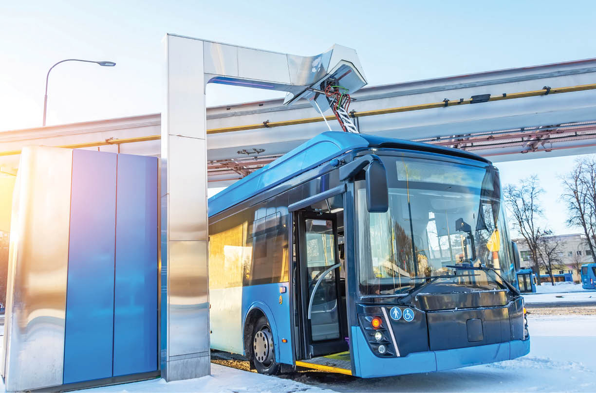 High-voltage electric charging station for charging electric buses at the final stop of the city route. Bus at the final stop with an open door